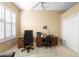 Home office featuring a large window with plantation shutters, two desks with office chairs, and a closet for storage at 842 Bentley Green Cir, Winter Springs, FL 32708