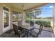 Enjoy outdoor dining on the screened patio with a table and chairs, overlooking the lush greenery of the yard at 842 Bentley Green Cir, Winter Springs, FL 32708