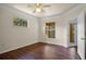 Comfortable bedroom features laminate wood floors and views of the private balcony at 8818 Villa View Cir # 304, Orlando, FL 32821
