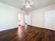 Spacious bedroom featuring a ceiling fan and beautiful wood-look flooring at 8818 Villa View Cir # 304, Orlando, FL 32821