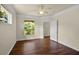 Comfortable bedroom featuring laminate wood floors and views of lush greenery outside at 8818 Villa View Cir # 304, Orlando, FL 32821