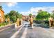 Secured community entrance with wrought iron gates and a paved road at 8818 Villa View Cir # 304, Orlando, FL 32821