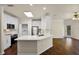 Open floor plan of the kitchen showing white cabinets, quartz countertops, and modern appliances at 8818 Villa View Cir # 304, Orlando, FL 32821