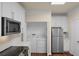 Well-organized kitchen features white cabinets, new appliances, and a convenient laundry closet at 8818 Villa View Cir # 304, Orlando, FL 32821
