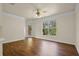 Spacious living room featuring laminate wood floors, fan, and lots of natural light at 8818 Villa View Cir # 304, Orlando, FL 32821