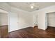 Comfortable primary bedroom featuring laminate wood flooring and an attached bathroom at 8818 Villa View Cir # 304, Orlando, FL 32821