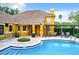 A beautiful community pool with a pergola-covered seating area and nice landscaping at 8818 Villa View Cir # 304, Orlando, FL 32821