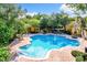 Sparkling community pool surrounded by lush landscaping and comfortable lounge chairs at 8818 Villa View Cir # 304, Orlando, FL 32821