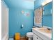 Clean and well-maintained bathroom with blue walls and updated fixtures at 99 Rainbow Dr. # 4, Haines City, FL 33844