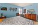 Spacious bedroom with light blue walls and neutral carpet and a comfortable bed at 99 Rainbow Dr. # 4, Haines City, FL 33844