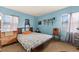Comfortable bedroom with natural light from two windows and light blue walls at 99 Rainbow Dr. # 4, Haines City, FL 33844