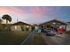 Charming single-story home with a well-maintained lawn, mature landscaping, and covered parking at 99 Rainbow Dr. # 4, Haines City, FL 33844