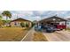 Exterior view of a well-maintained house with a fenced yard and convenient parking at 99 Rainbow Dr. # 4, Haines City, FL 33844