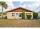 Charming one-story home with wood trim and well-kept landscaping and bright red shutters at 99 Rainbow Dr. # 4, Haines City, FL 33844