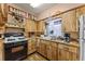 Bright kitchen featuring wood cabinets, modern appliances, and ample counter space at 99 Rainbow Dr. # 4, Haines City, FL 33844