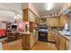 The kitchen features wood cabinets, an oven, a sink, and ample countertop space at 99 Rainbow Dr. # 4, Haines City, FL 33844