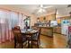 The kitchen features a ceiling fan and wood cabinets with a table and chairs at 99 Rainbow Dr. # 4, Haines City, FL 33844