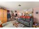 Cozy living room with a comfortable gray sofa and a view of the kitchen area at 99 Rainbow Dr. # 4, Haines City, FL 33844