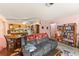 Open-concept living room and kitchen with wood floors, a ceiling fan, and neutral paint at 99 Rainbow Dr. # 4, Haines City, FL 33844
