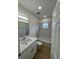 Bathroom with modern white vanity, tile tub surround, and ample lighting at 1007 Colyer St, Orlando, FL 32805