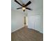 Bedroom features a modern ceiling fan, wood-look floors, and a spacious closet at 1007 Colyer St, Orlando, FL 32805