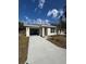 One-story home with an attached garage and freshly landscaped front yard, offering great curb appeal at 1007 Colyer St, Orlando, FL 32805