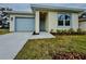 Charming single-story home with a gray garage door, complemented by fresh landscaping at 1007 Colyer St, Orlando, FL 32805