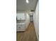 Bright hallway featuring hardwood floors and neutral-colored walls, leading to a door at 1007 Colyer St, Orlando, FL 32805