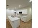 Kitchen featuring an island with quartz countertops, white cabinets, and stainless steel appliances at 1007 Colyer St, Orlando, FL 32805