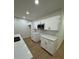 Kitchen featuring white cabinets, quartz countertops, stainless steel appliances, and wood flooring at 1007 Colyer St, Orlando, FL 32805
