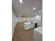 Bright kitchen featuring an island, white cabinets, stainless steel appliances, and wood flooring at 1007 Colyer St, Orlando, FL 32805