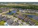 Aerial view of the house and neighborhood near a pond at 10742 Belle Maisons Dr, Orlando, FL 32832