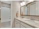 Clean bathroom with double sinks, a large mirror, and a shower/tub combo at 10742 Belle Maisons Dr, Orlando, FL 32832