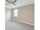 Empty bedroom featuring neutral walls, carpet, and a window with plantation shutters at 10742 Belle Maisons Dr, Orlando, FL 32832