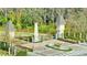 Elegant community entrance with decorative towers, a statue, fountain and wrought iron gates at 10742 Belle Maisons Dr, Orlando, FL 32832