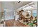 Elegant dining room featuring coffered ceilings, a large wooden table, and ample natural light at 10742 Belle Maisons Dr, Orlando, FL 32832