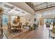 Spacious dining area with coffered ceilings leading to a bright and airy living room at 10742 Belle Maisons Dr, Orlando, FL 32832