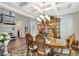 Elegant dining room with coffered ceilings, chandelier, and seating for six guests at 10742 Belle Maisons Dr, Orlando, FL 32832