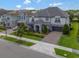 An aerial view of the front exterior of the two-story home showcasing landscaping and a driveway at 10742 Belle Maisons Dr, Orlando, FL 32832