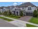 Attractive exterior view of a home with manicured landscaping and a paver driveway at 10742 Belle Maisons Dr, Orlando, FL 32832
