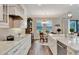 Bright kitchen featuring a breakfast nook, modern cabinetry, and granite countertops at 10742 Belle Maisons Dr, Orlando, FL 32832