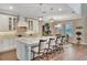 Open-concept kitchen with island seating, pendant lighting, and a view of the dining area at 10742 Belle Maisons Dr, Orlando, FL 32832