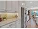 Bright kitchen with stainless steel appliances, subway tile backsplash, and granite countertops at 10742 Belle Maisons Dr, Orlando, FL 32832