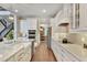 Spacious kitchen with double ovens, island seating, and views into the dining room at 10742 Belle Maisons Dr, Orlando, FL 32832