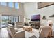 Living area boasts high ceilings, wood floors, backyard pool view and refined decor for relaxed elegance at 10742 Belle Maisons Dr, Orlando, FL 32832