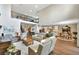 Open-concept living area with soaring ceilings, wood-look flooring and loft overlooking modern, airy spaces at 10742 Belle Maisons Dr, Orlando, FL 32832