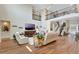 Spacious living area features tall ceilings, wood floors, plush seating, and a staircase to an upper level at 10742 Belle Maisons Dr, Orlando, FL 32832