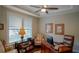 Comfortable home office featuring a ceiling fan, a desk, and an accent chair at 10742 Belle Maisons Dr, Orlando, FL 32832