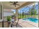 Screened-in lanai with a ceiling fan, seating area, and a pool with an attached spa in the backyard at 10742 Belle Maisons Dr, Orlando, FL 32832
