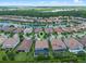 A beautiful aerial view of the property surrounded by lush landscapes and a lake view at 10819 Savona Way, Orlando, FL 32827